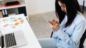 Profesional consultando el móvil en su mesa de trabajo
